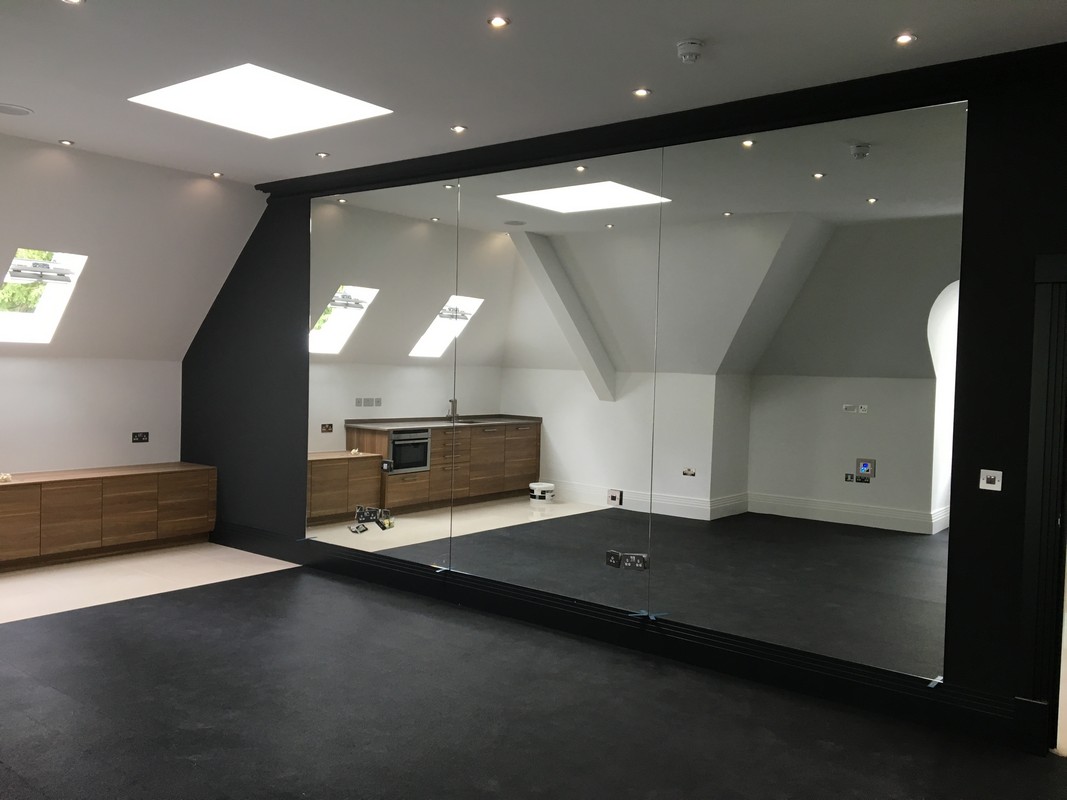 Frameless glass wall dividing loft conversion in Slough