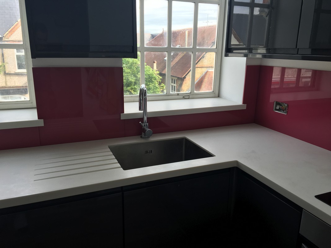 Deep plum coloured glass splashback in modern Slough kitchen